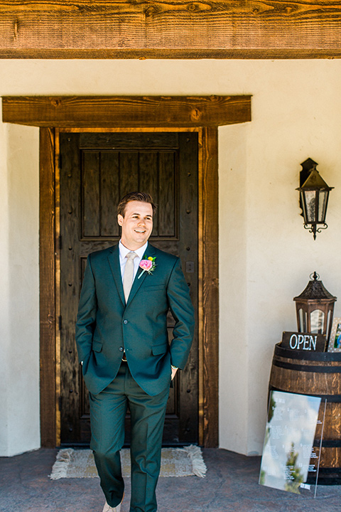 Topa-Winery-Wedding-groom-standing-in-a-green-suit-with-a-tan-long-tie-with-brown-shoes