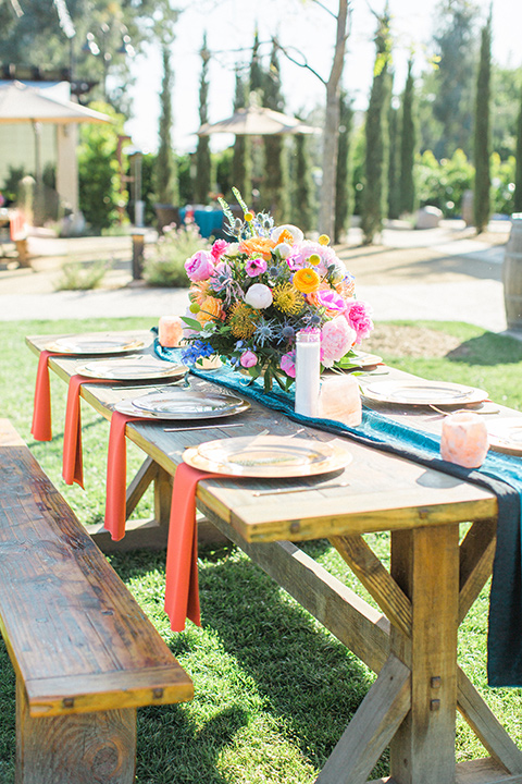 Topa-Winery-Wedding-table-set-up-with-picnic-tables-and-bright-colors-décor-with-gold-plates-and-flatware