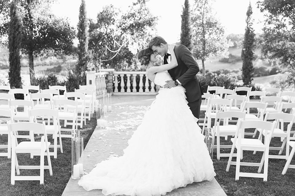 Vellano-Country-Club-black-and-white-photo-bride-and-groom-touching-heads-bride-in-a-ballgown-with-her-hair-up-groom-in-a-charcoal-grey-tuxedo