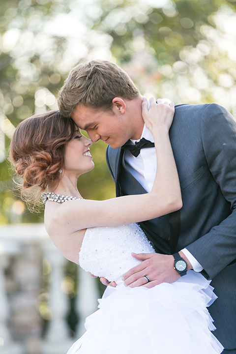 Vellano-Country-Club-bride-and-groom-touching-heads-bride-in-a-strapless-ballgown-groom-in-a-grey-tuxedo