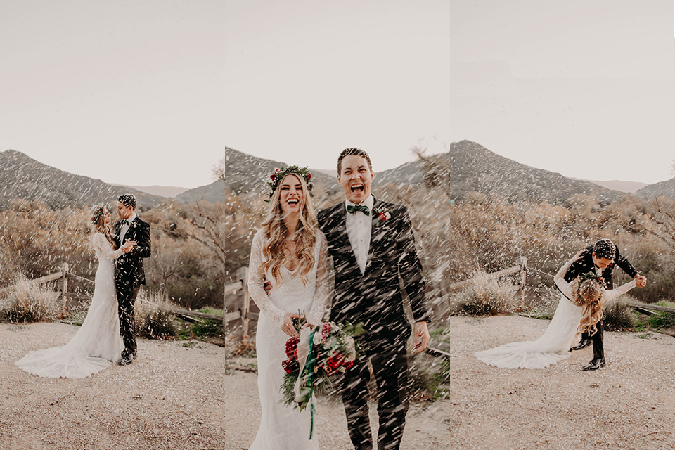 bride and groom in snow, the groom in a black suit with a  green velvet bow tie and the bride in a long sleeved lace gown and a boho floral headpiece