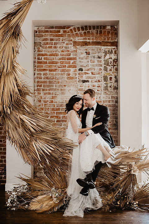 The-Yost-Theatre-bride-and-groom-by-moon-design-bride-in-a-modern-silk-gown-with-a-sheer-beaded-overlay-groom-in-a-black-velvet-tuxedo