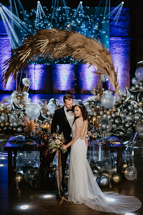 The-Yost-Theatre-bride-and-groom-with-theater-spacce-and-balloons-bride-in-a-modern-gown-with-jeweled-detailing-groom-in-a-velvet-tuxedo