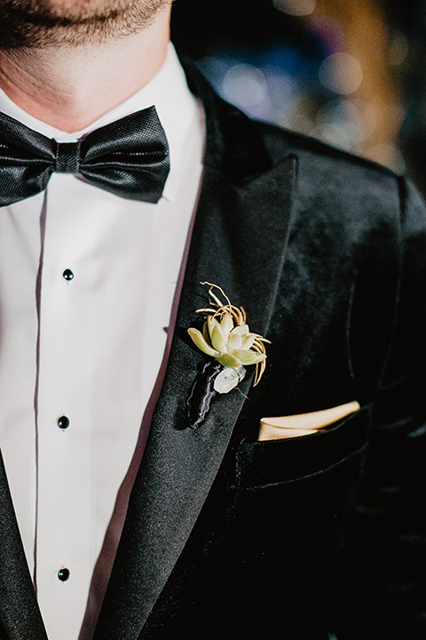 The-Yost-Theatre-close-up-on-groom-attire-in-a-modern-black-velvet-tuxedo