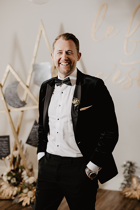 The-Yost-Theatre-groom-smiling-alone-groom-in-a-velvet-tuxedo