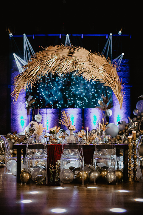 The-Yost-Theatre-table-set-up-with-gold-and-silver-balloons-and-modern-clear-furniture