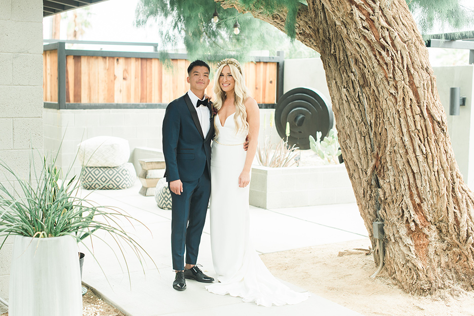 the-lautner-compound-bride-and-groom-smiling-bride-wore-a-lace-fitted-gown-and-groom-in-a-bue-shawl-lapel-tuxedo