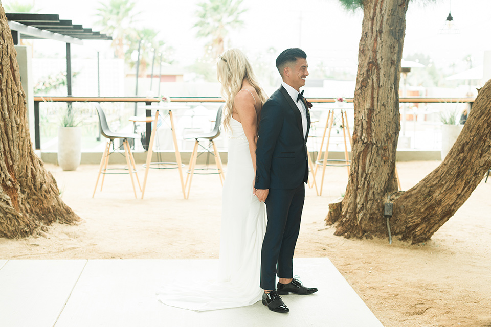 the-lautner-compound-wedding-bride-and-groom-firstlook-bride-in-a-form-fitting-lace-gown-groom-in-a-navy-shawl-lapel-tuxedo