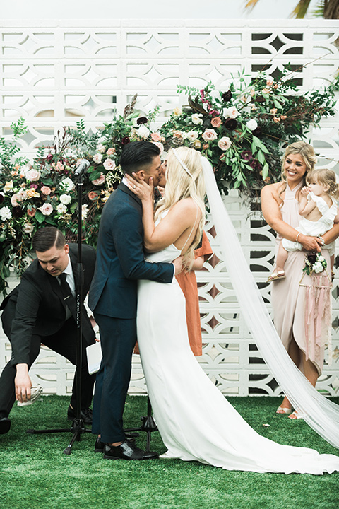 the-lautner-compound-wedding-ceremony-kiss-the-bride-wore-a-formfitting-lace-gown-with-strap-groom-wore-a-blue-shawl-lapel-tuxedo