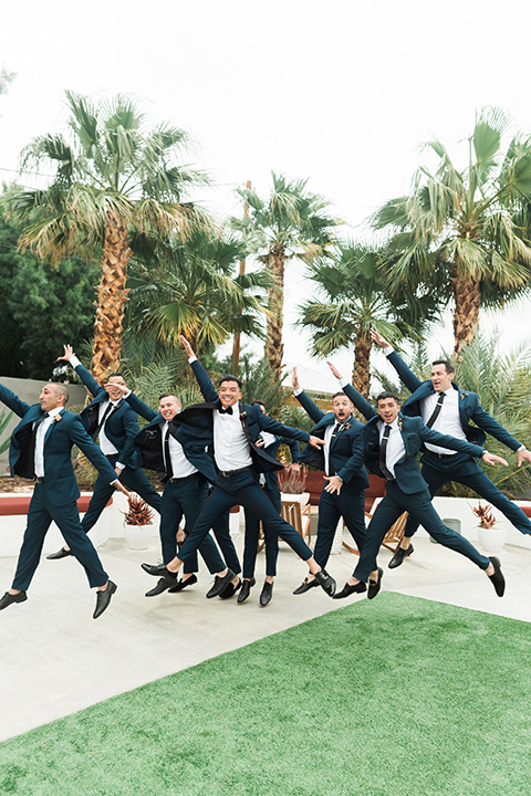 the-lautner-compound-wedding-groomsmen-jumping-in-navy-suits-and-tuxedos