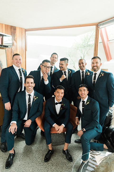 the-lautner-compound-wedding-groomsmen-sitting-groomsmen-in-blue-suts-and-groom-in-a-navy-shawl-lapel-tuxedo