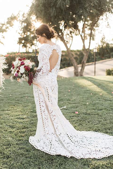 Temecula-outdoor-wedding-at-callaway-winery-bride-holding-bouquet-back-of-dress