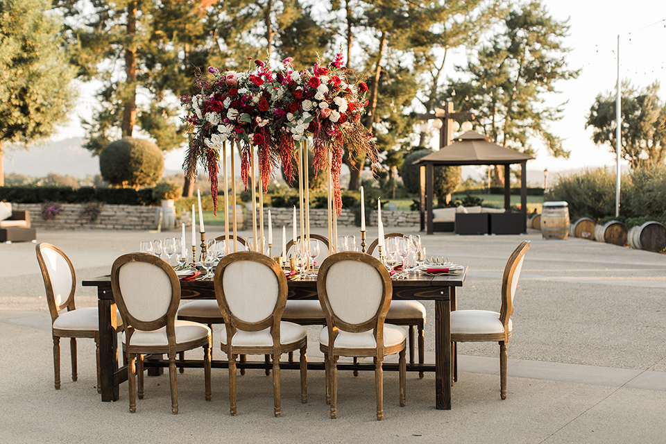 Temecula-outdoor-wedding-at-callaway-winery-table-set-up-with-dee-red-and-maroon-florals