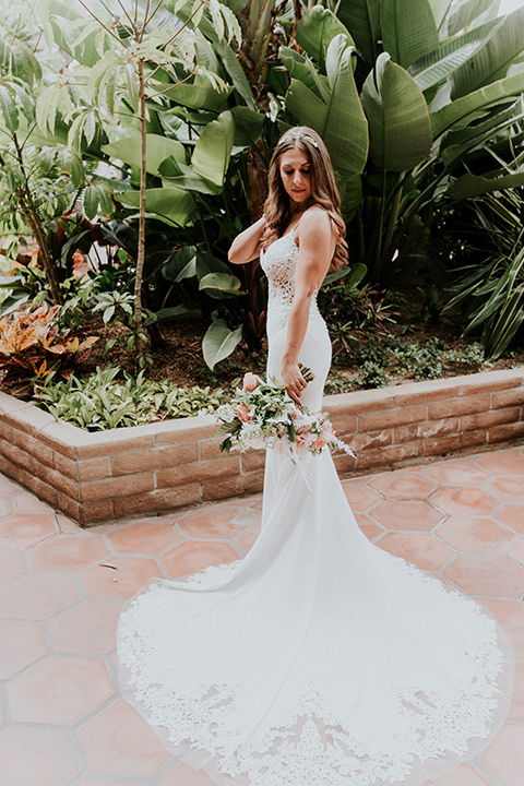 la-jola-shores-hotel-wedding-bride-looking-down-bride-in-a-satin-gown-with-a-silver-bodice-and-straps