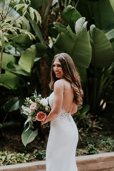 la-jola-shores-hotel-wedding-bride-looking-over-her-shoulder-in-a-silk-fitted-gown-with-straps