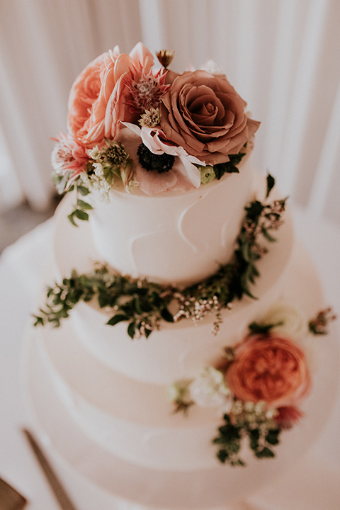 la-jola-shores-hotel-wedding-cake-with-white-fondant-and-roses-on-it