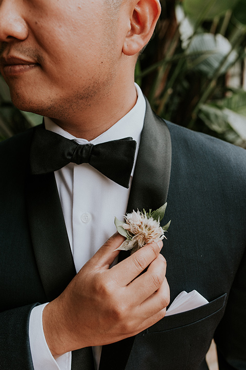 la-jola-shores-hotel-wedding-close-up-on-groom-with-a-navy-shawl-lapel-tuxedo-with-black-trim