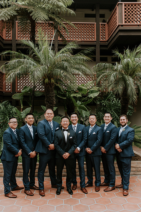 la-jola-shores-hotel-wedding-groomsmen-standing-smiling-at-camera-with-navy-suits-on