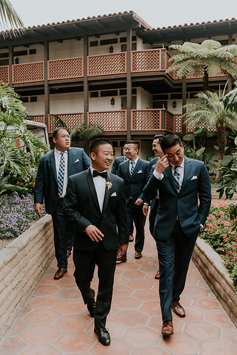 la-jola-shores-hotel-wedding-groomsmen-walking-in-navy-tuxedos