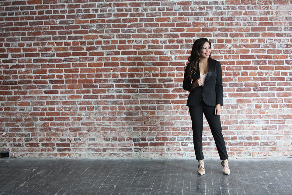 female-model-in-front-of-a-brick-wall-wearing-a-black-shawl-lapel-tuxedo