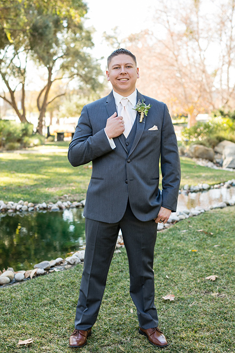 gallway-downs-wedding-groom-standing-holding-coat-groom-in-a-dark-grey-suit-and-nude-long-tie