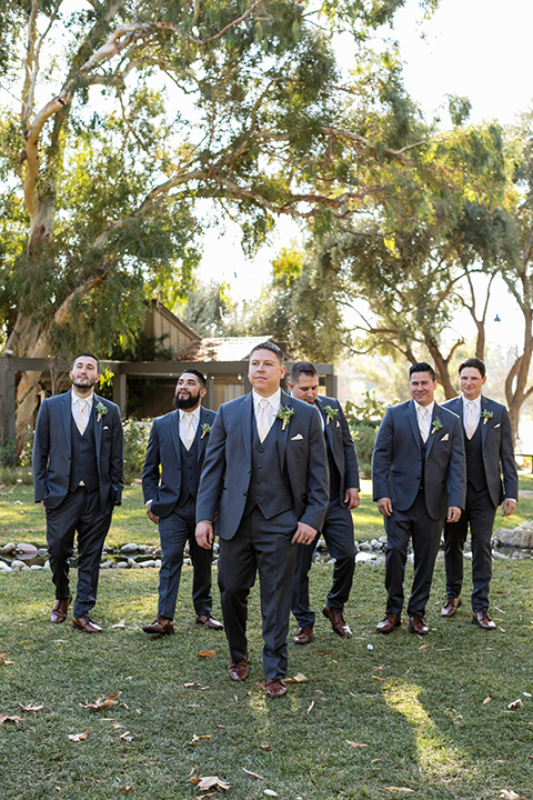 gallway-downs-wedding-groomsmen-walking-in-charcoal-tuxedos-and-neutral-color-ties