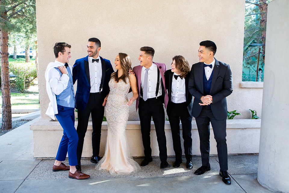 Group of friends in tuxedos and dresses ready for prom