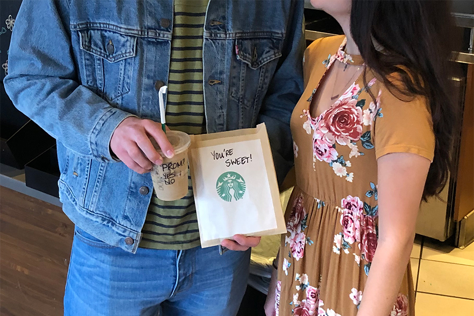 promposal: guy spelled out prom on starbucks drink and bag of cookies says "you're sweet"