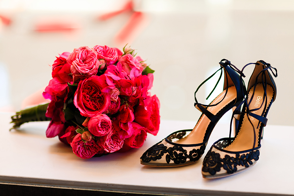 Intercontinental-DTLA-shoot-bridal-accessories-shot-with-the-bridal-shoes-with-black-lace-detailing-and-red-rose-bouquet