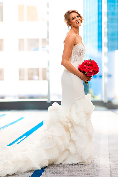 Intercontinental-DTLA-shoot-bride-standing-holding-her-bouquet-in-a-strapless-dress