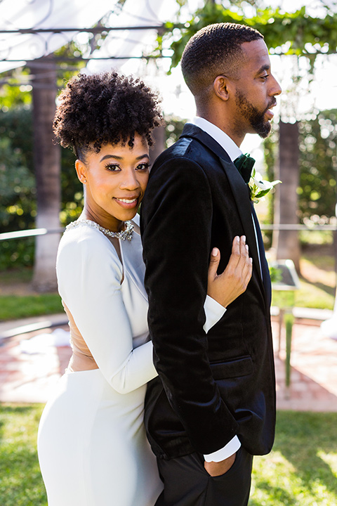 muckenthaler-mansion-bride-and-groom-close-up-bride-looking-at-camera-in-a-satin-gown-with-an-illusion-back-and-groom-in-a-black-velet-tux