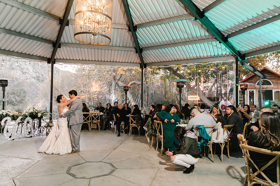 hidden-acres-wedding-first-dance-bride-in-fitted-gown-with-an-illusion-neckline-and-groom-in-a-grey-suit-with-a-white-bow-tie