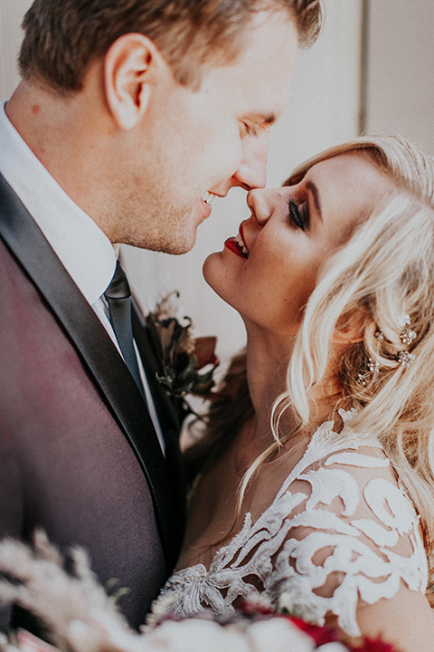 orange-county-vow-renewal-bride-and-groom-close-up-bride-in-a-lace-modern-fitted-gown-with-a-nude-underlay-groom-in-a-burgundy-tuxedo-with-a-black-shawl-lapel