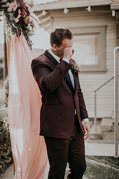 orange-county-vow-renewal-groom-crying-groom-in-a-burgundy-tuxedo-with-a-black-shawl-lapel