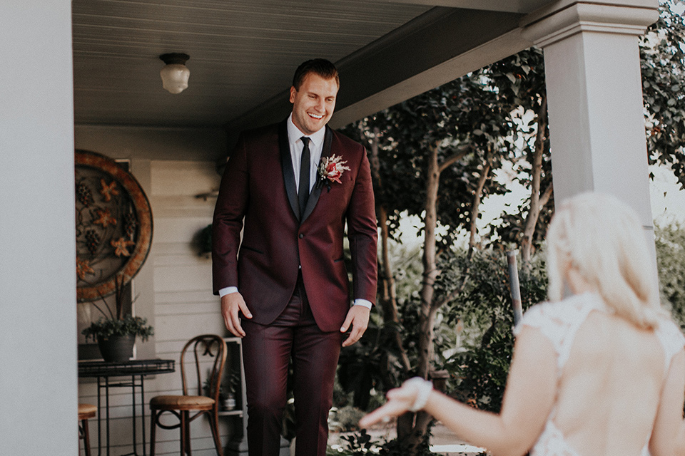 orange-county-vow-renewal-groom-seeing-bride-bride-in-a-lace-modern-fitted-gown-with-a-nude-underlay-groom-in-a-burgundy-tuxedo-with-a-black-shawl-lapel