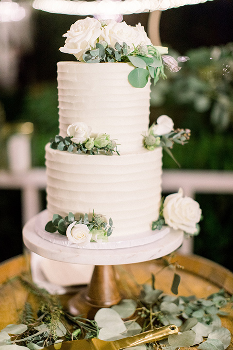  white three tiered cake with green accents