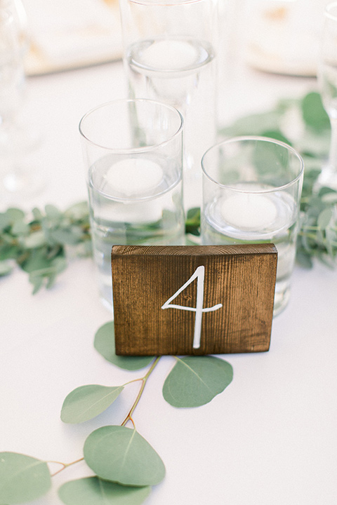  white linens with sage and wooden number cards