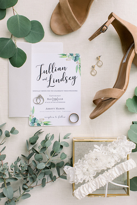  white invitations with greenery decor