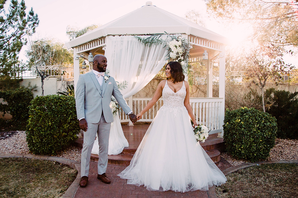 llittle-chapel-on-the-corner-las-vegas-wedding-shoot-bride-and-groom-holding-hands-bride-wearing-a-tulle-ballgown-groom-wearing-a-light-grey-suit