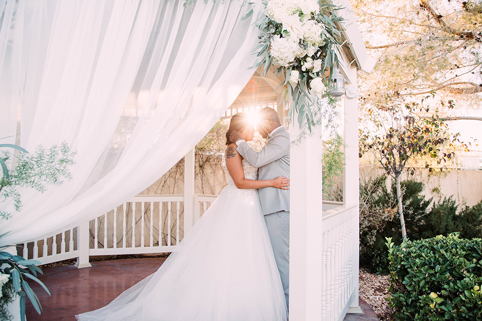 little-chapel-on-the-corner-las-vegas-wedding-shoot-bride-and-groom-in-gazeebo-while-the-bride-wore-a-tulle-ballgown-with-skinny-straps-and-the-groom-wore-a-heather-grey-suit