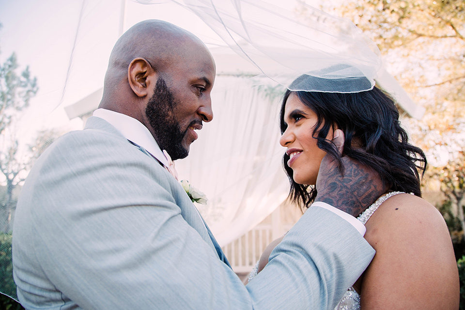 little-chapel-on-the-corner-las-vegas-wedding-shoot-bride-and-groom-under-veil-the-bride-wore-a-tulle-ballgown-with-skinny-straps-and-the-groom-wore-a-heather-grey-suit