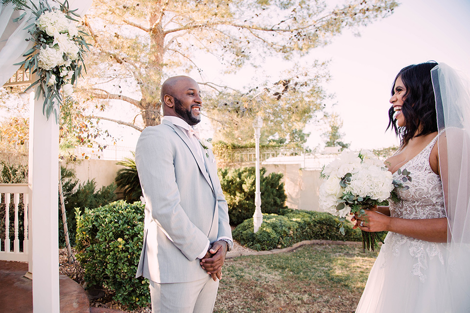 little-chapel-on-the-corner-las-vegas-wedding-shoot-first-look-the-bride-wore-a-tulle-ballgown-with-skinny-straps-and-the-groom-wore-a-heather-grey-suit