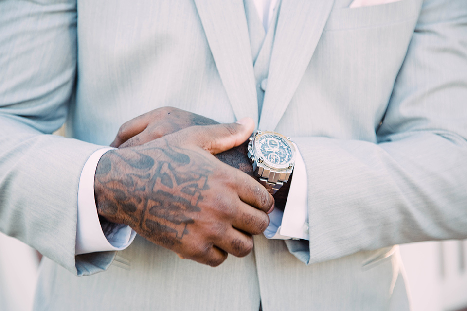 little-chapel-on-the-corner-las-vegas-wedding-shoot-groom-close-up-on-watchin-a-groom-wore-a-heather-grey-suit