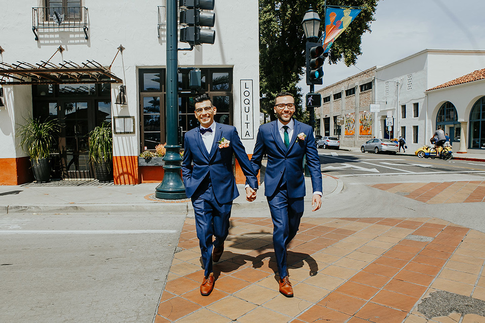 loquita-shoot-grooms-crossing-the-street-grooms-in-cobalt-blue-suits-with-one-with-a-green-tie-and-the-other-with-a-blue-bow