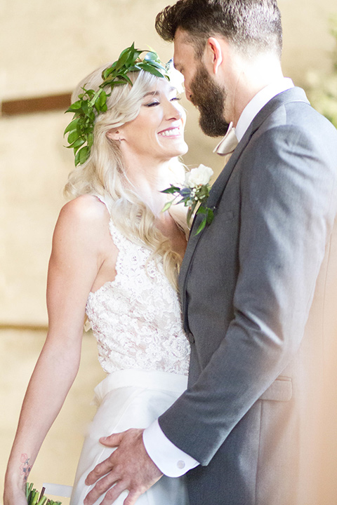 luce-loft-bride-and-groom-in-ceremony-space-bride-in-a-fit-and-flare-gown-with-straps-groom-in-a-charcoal-suit-with-champagne-bow-tie