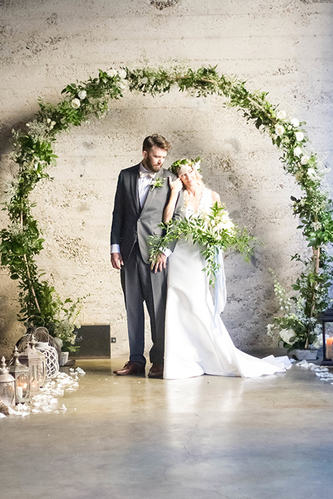 luce-loft-ceremony-bride-in-a-fit-and-flare-gown-with-straps-groom-in-a-charcoal-suit-with-champagne-bow-tie