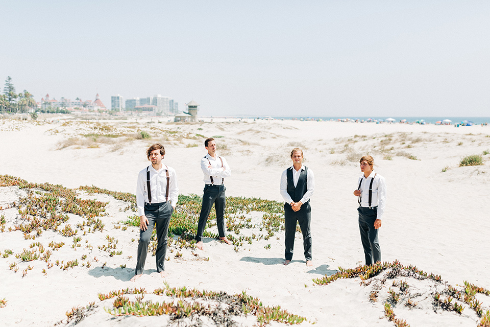 San-Diego-Beach-wedding-groomsmen-groomsmen-in-suit-pants-and-suspenders-bride-ina-lace-formitting-dress-with-strapsand-a-veil-groom-in-a-suit-pants-and-vest