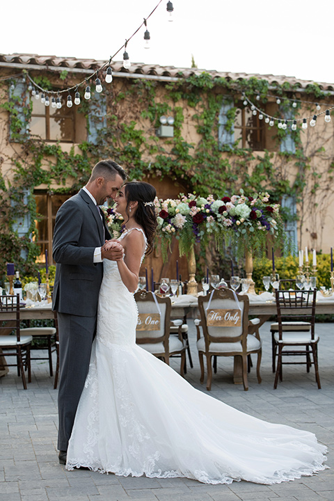 milagro-farms-shoot-couple-dancing-bride-in-a-fitted-lace-gown-with-straps-groom-in-a-charcoal-suit-with-a-purple-tie