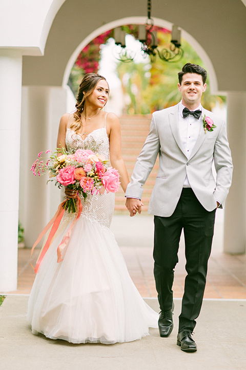 omni-la-costa-bride-and-groom-bride-wearing-a-lace-fitted-gown-with-mermaid-style-with-thin-straps-groom-with-light-grey-jacket-with-black-pants-black-polka-dot-bowtie