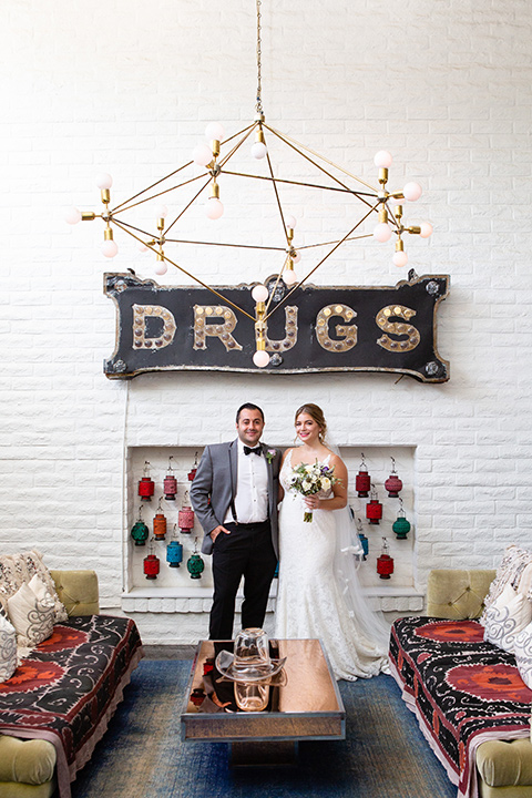 Palm-Springs-wedding-at-the-parker-bride-and-groom-by-drugs-sign-bride-alone-in-a-flowing-gown-and-a-deep-v-neckline